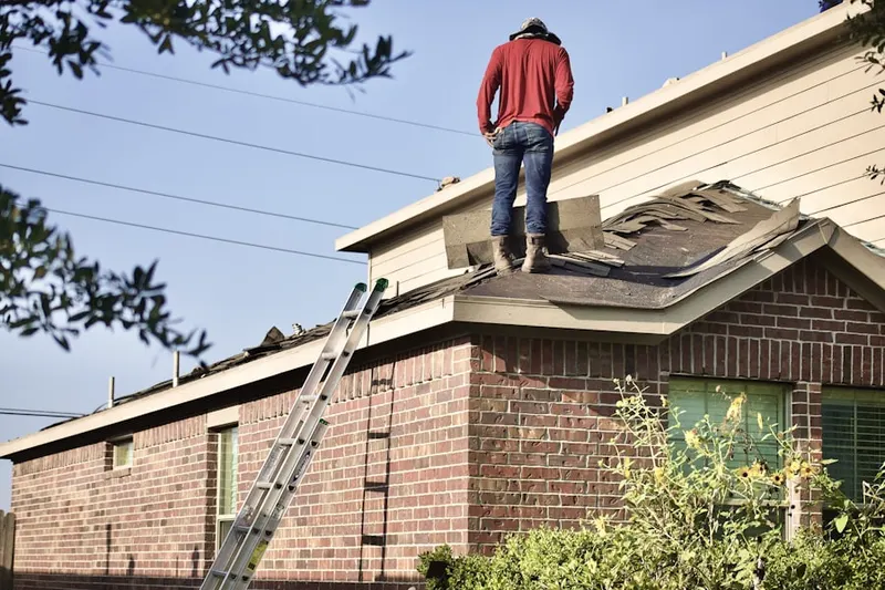 Professional roofer working on a residential roof in Grosse Pointe